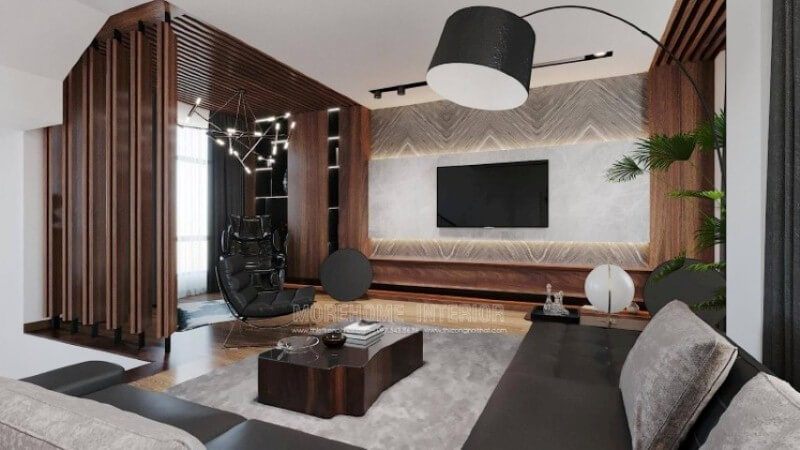 Là một trong những ý tưởng thiết kế nội thất phòng khách biệt thự cao cấp được thiết kế theo lối hiện đại nhưng lại sử dụng chất liệu gỗ làm chủ đạo đã tạo nên vẻ đẹp độc đáo, mới lạ trong Vinhomes Imperia Hải Phòng. Gỗ được biến hóa độc đáo nhưng lại mang tính liền mạch, từ chất liệu làm kệ trang trí, gỗ ốp tường, tạo điểm nhấn đến kệ trang trí. Tuy nhiên không làm cho không gian bị trầm, bởi sự kết hợp khéo léo khi sử dụng chất liệu đá ốp tường có độ bóng sang cùng gam màu tương phản, kết hợp cùng màu đơn sắc trần thạch cao đã làm không gian như trở thành bức tranh hài hòa nhưng lại cuốn hút không ngờ.
